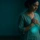 Mujer con las manos sobre el pecho en una práctica para limpiar tu campo energético al atardecer